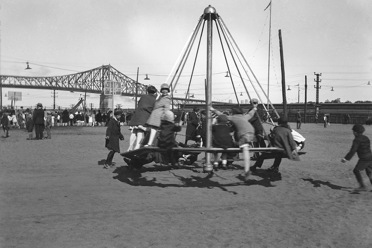Harry Sutcliffe, <i>Children on a merry-go-round in a park near Jacques-Cartier Bridge</i>, Montreal, about 1935, reversed negative (12.5 × 17.9 cm), gift of Peter, Paul, Robert and Carolyn Sutcliffe, McCord Museum, M2011.64.2.202